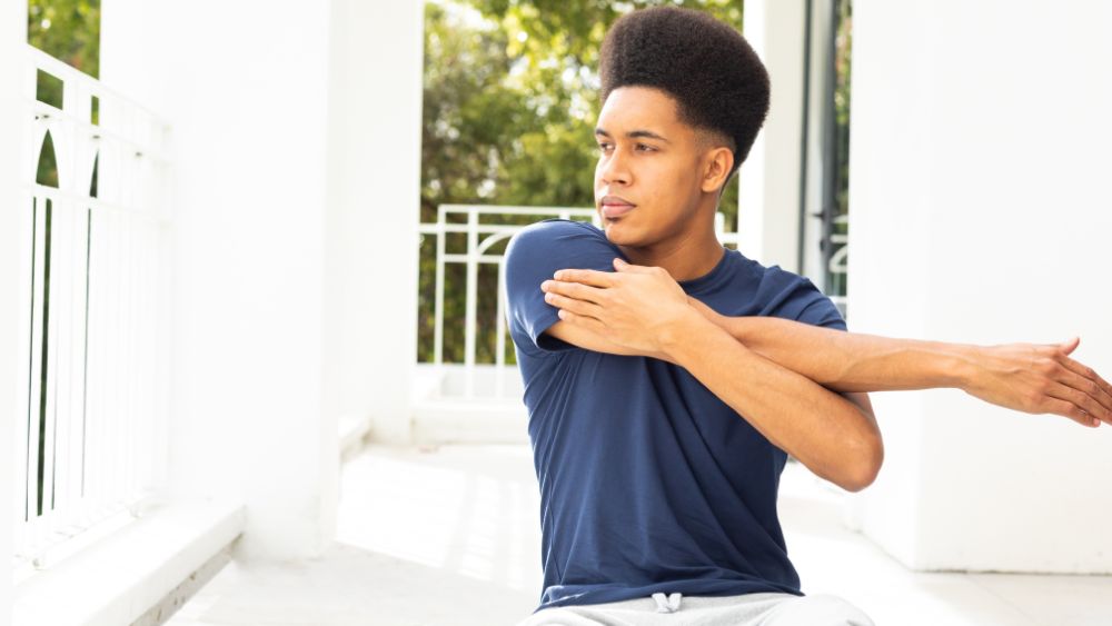 Person stretching or holding rib muscles after exercise